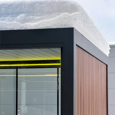 Modern pergola corner with glass facade and snow on roof
