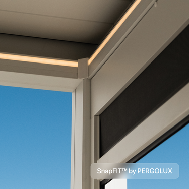 Window frame with SnapFIT by PERGOLUX branding against a blue sky