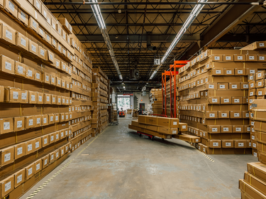 Pergolux Warehouse with stacked cardboard boxes on pallets