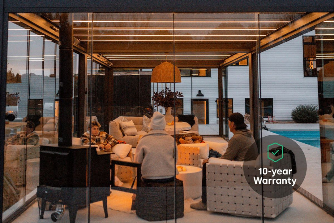 Family enjoying winter weather under a Pergolux Skydance with LED lights, and a heater.