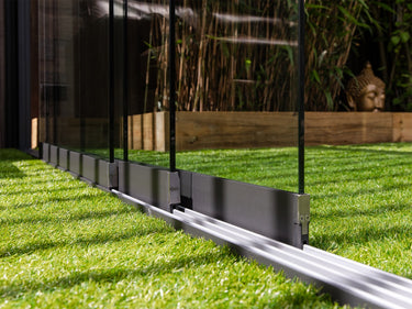 Clear tempered safety glass in matte black posts with dark grey kick plate and silver bolts on sliding track