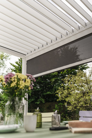 dark grey privacy screen partially retracted under louvered roof