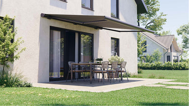 Dark brown retractable awning brackets shading patio dining set on white textured wall