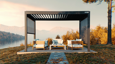Patio with outdoor furniture under a pergola by a lake during sunset.