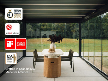 Skydance S3 pergola interior with glass walls, terrazzo table, and award logos