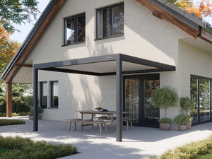 Dark grey matte PERGOLUX Pergola 4 with closed louvres shading wooden dining set on patio