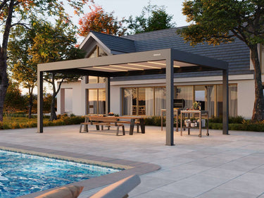 Full span dark grey Pergola 4 Pro Max with illuminated ceiling panels covering outdoor dining area