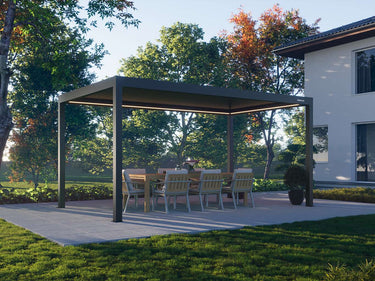 Free-standing dark grey aluminum pergola with closed louvered roof in garden setting