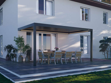 Motorised pergola attached to house wall with illuminated under-beam lighting