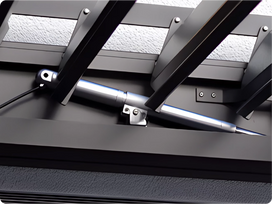 Close-up of a mechanical device with a metallic component on a textured surface