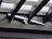 Close-up of a mechanical device with a metallic component on a textured surface
