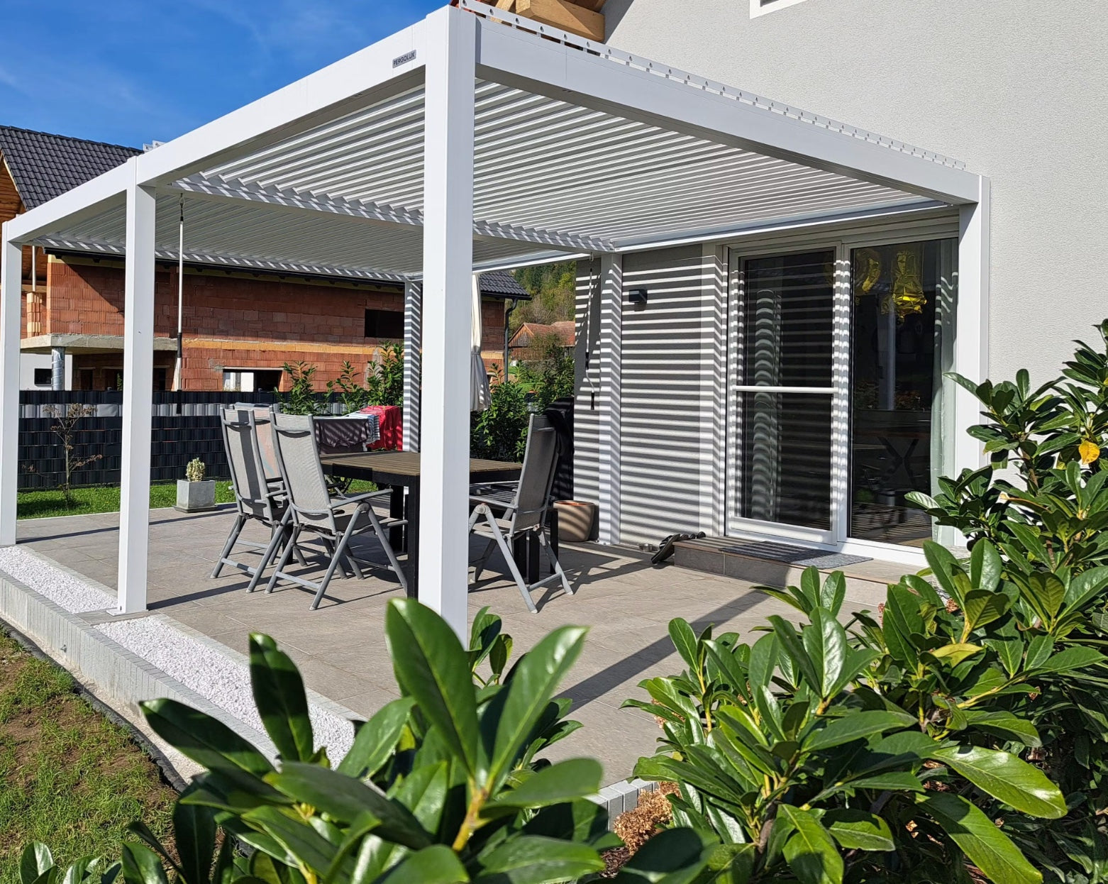 Patio with pergola, outdoor furniture, and garden setting