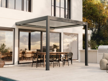 Dark grey aluminum pergola with active rafter LED lights illuminating patio near glass doors