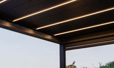 Low angle close-up of black Pergola 4 Pro Max underside showing three parallel warm white light strips