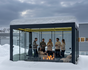 Glass-walled Pergola 4 Pro covered in snow demonstrating all-weather capability with warm yellow LED lighting