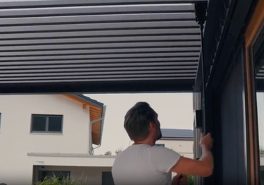 Close up of adjustable louvered roof slats and vertical side screen rail mechanism