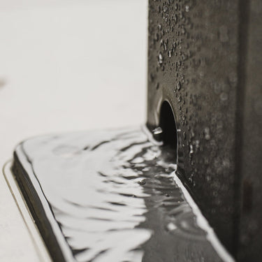 Close-up of a smartphone with water droplets on its screen and back Pergola