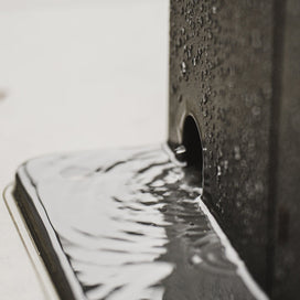 Close-up of a smartphone with water droplets on its screen and back Pergola
