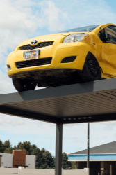 Yellow car on a pergolux pergola  against a blue sky with clouds