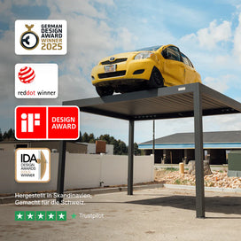 Yellow car on a metal carport pergola with design award logos displayed.