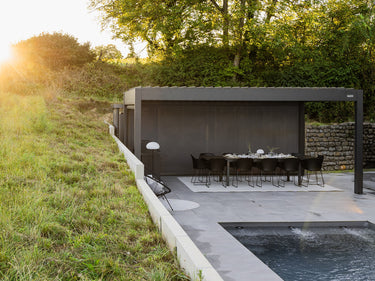 dark enclosed pergola with full side screening at sunset