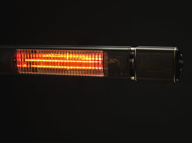 Close-up of black rectangular patio heater highlighting bright orange internal heating tubes behind ribbed glass